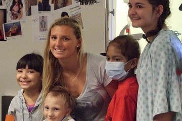 Lakey Peterson posing with patients in Seacrest Studio