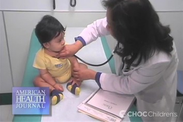 Toddler being examined by Dr. Morchi in clinic