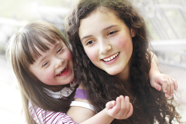 Down syndrome girl with her sister