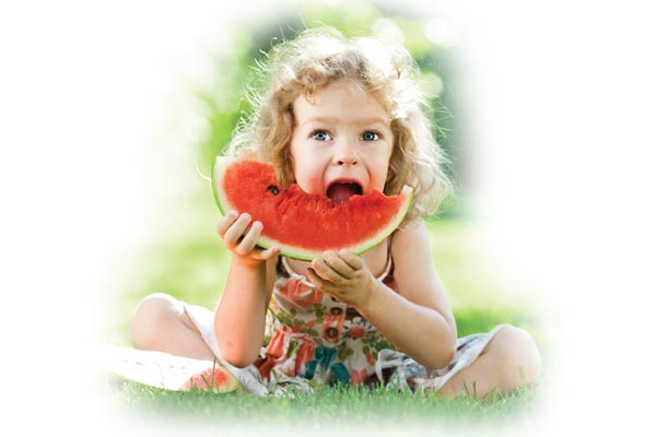 Young girl eating watermelon