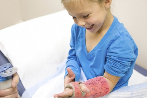 Smiling girl with a cast on her arm