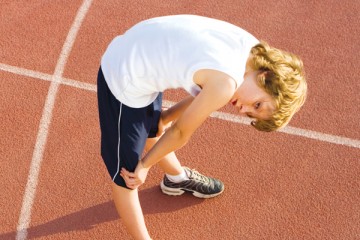 Young athlete bent over resting