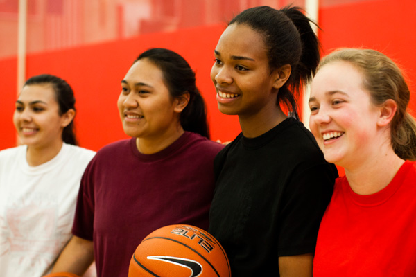 Smiling teen girls on a basketball team