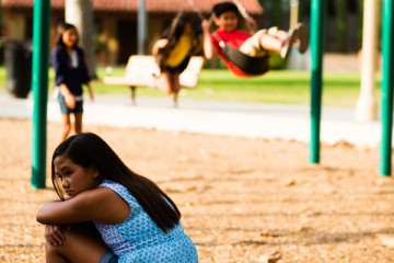 Young girl sitting in a playground