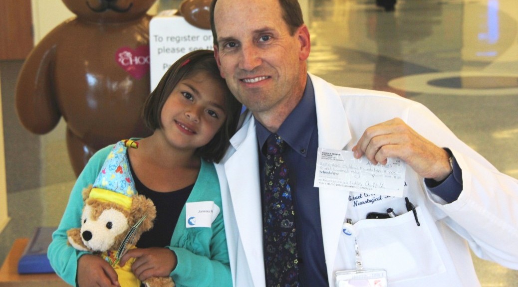 CHOC patient Juneau Resnick poses with Dr. Michael Muhonen, medical director of The CHOC Children’s Neuroscience Institute