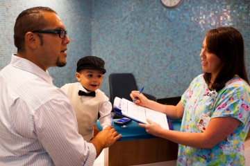 Nurse with dad and son in the reception area