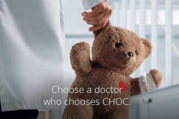 Physician holding teddy bear