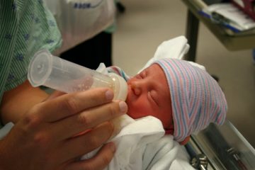 Baby being fed a bottle