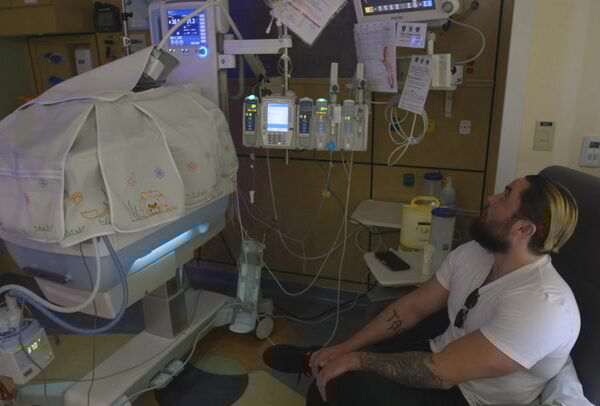 Dad at bedside of child in NICU