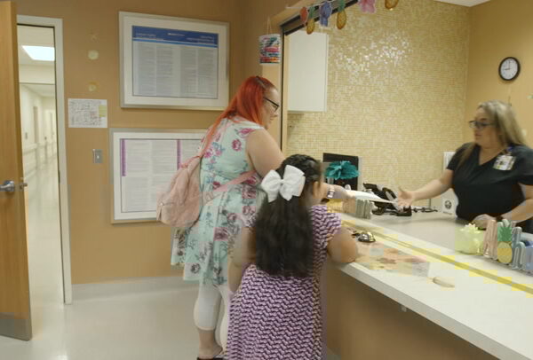 Mom and daughter at the clinic reception desk