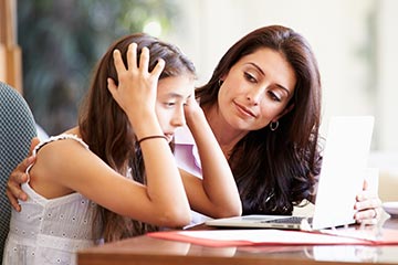 Mom talking with troubled girl