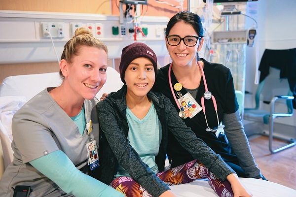 oncology patient smiling with her nurses