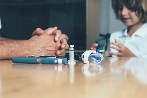Adult and child with diabetes monitoring equipment
