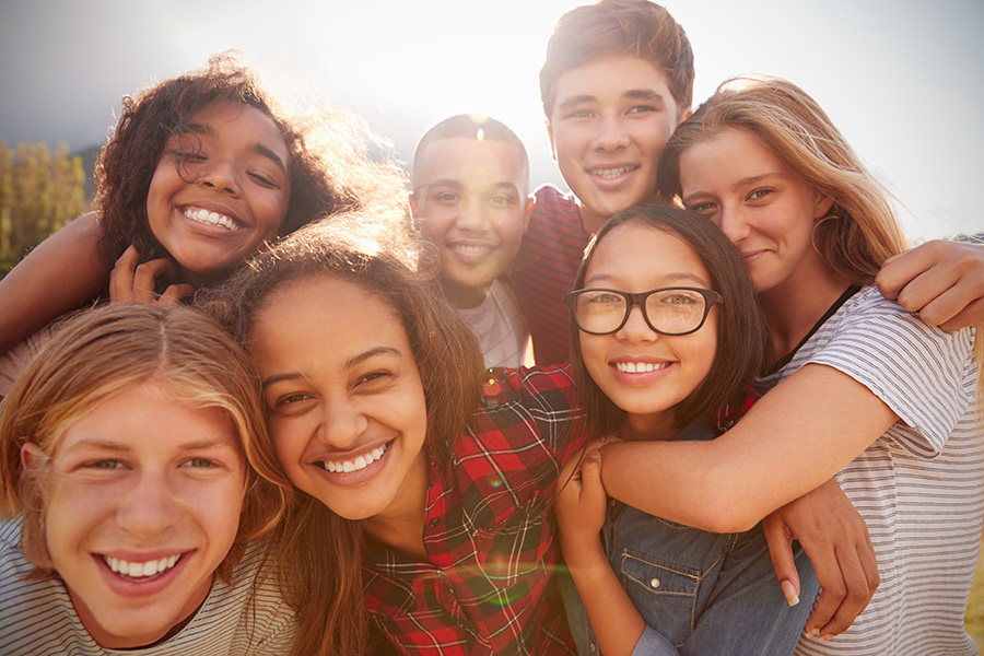 Group of adolescents smiling together