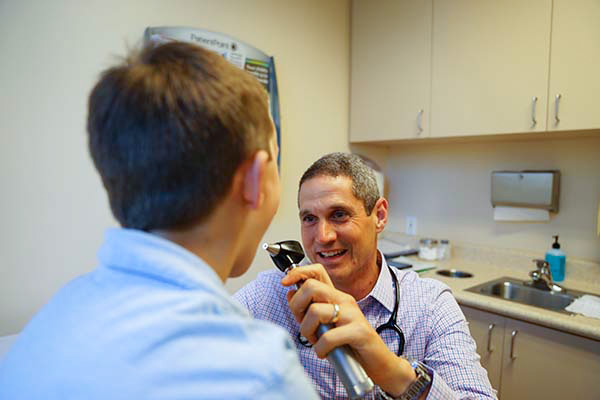 Doctor looks in patient's mouth