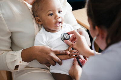baby being checked with a stethoscope