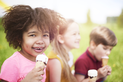 Young kids eat ice cream together