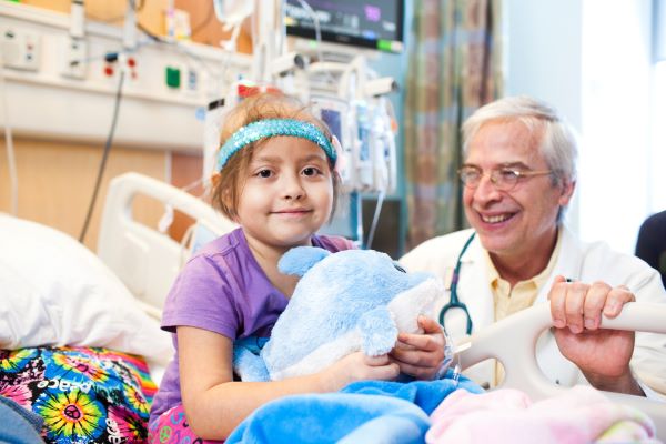 Dr. Antonio Arrieta, infectious disease specialist, visits a young female patient at CHOC