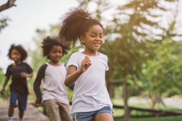 Young kids run together outside