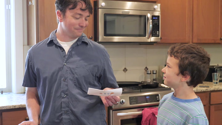 child handing father a note
