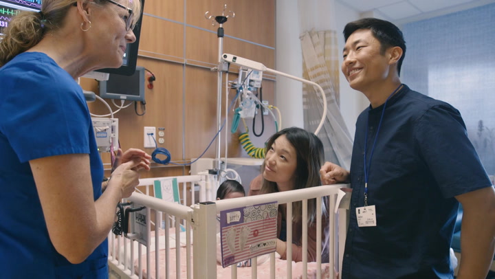 Parents in the NICU with their child and nurse