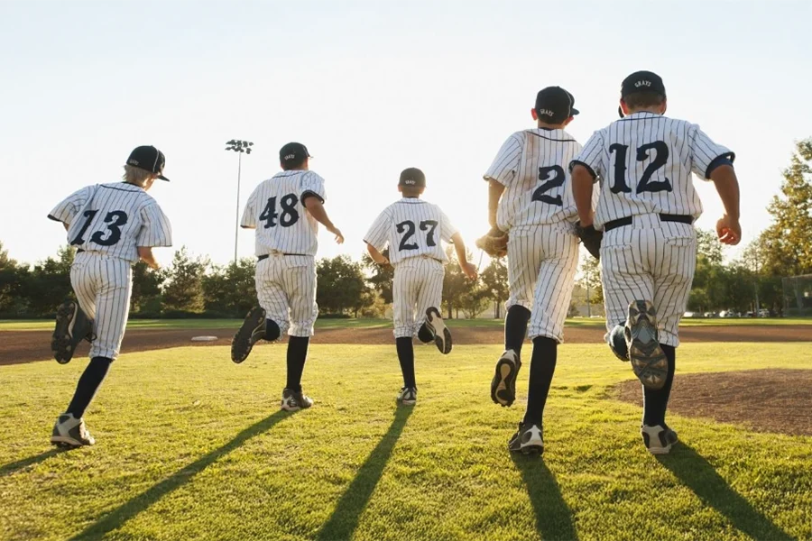 young boys running on a baseball field