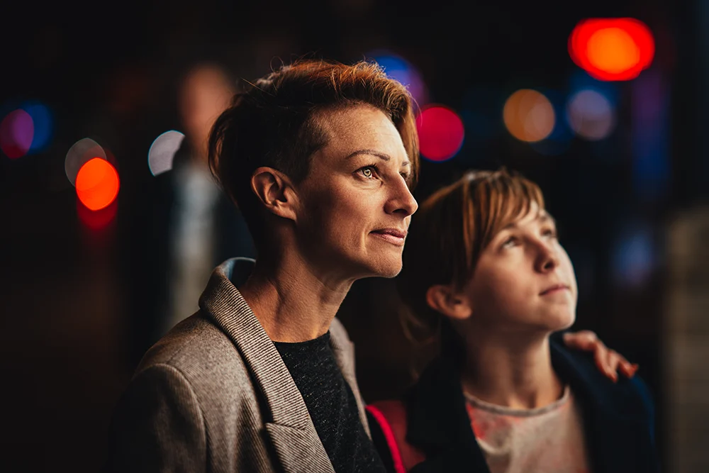 mother embraces teen daughter in city