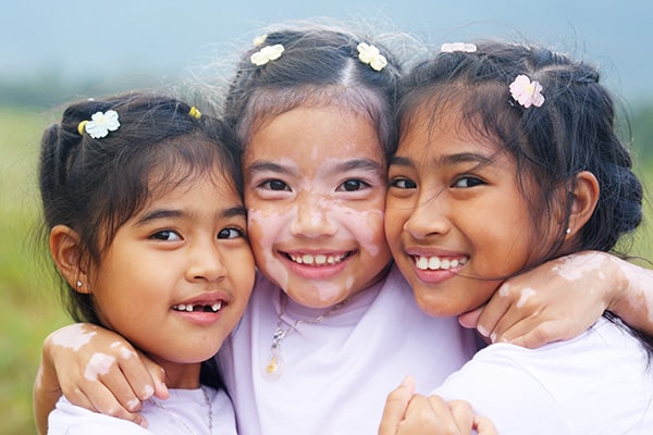 Three girls smiling together