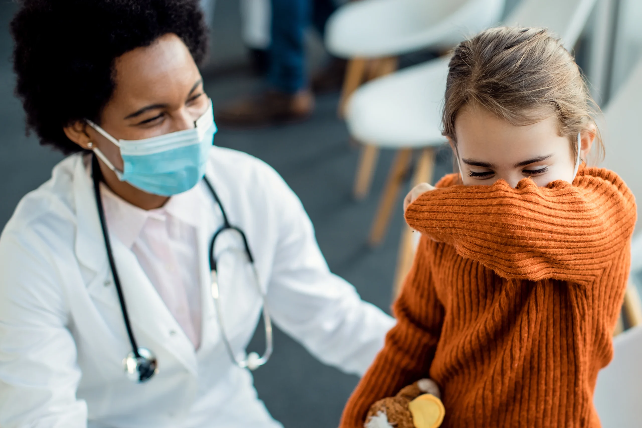doctor with coughing little girl
