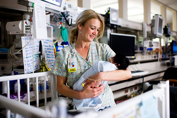 Nurse holds baby CHOC patient