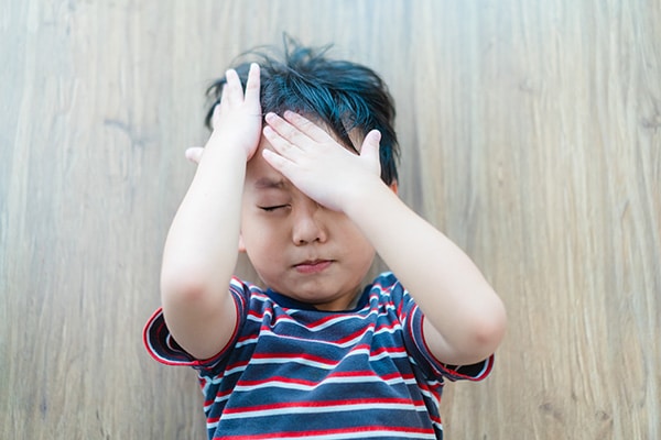 Child holding head