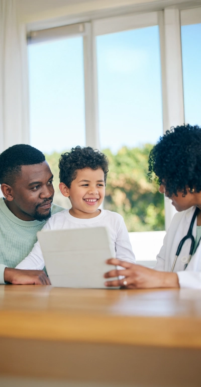 father and son consulting with doctor