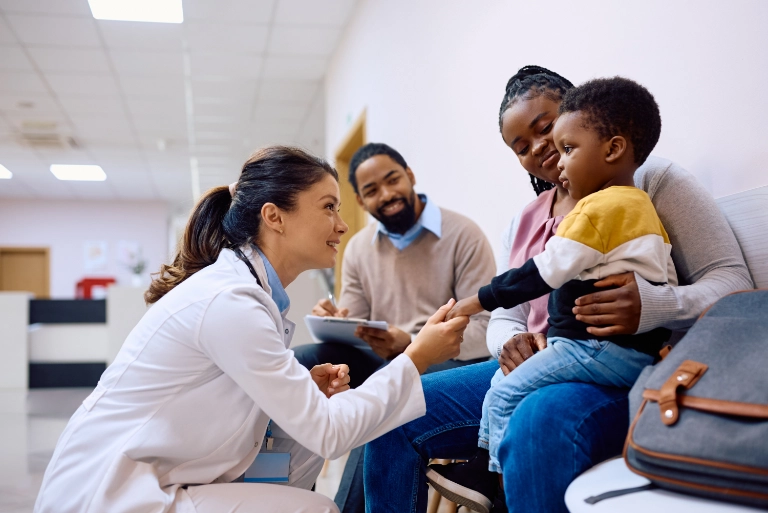 helpful female doctor holding childs hand