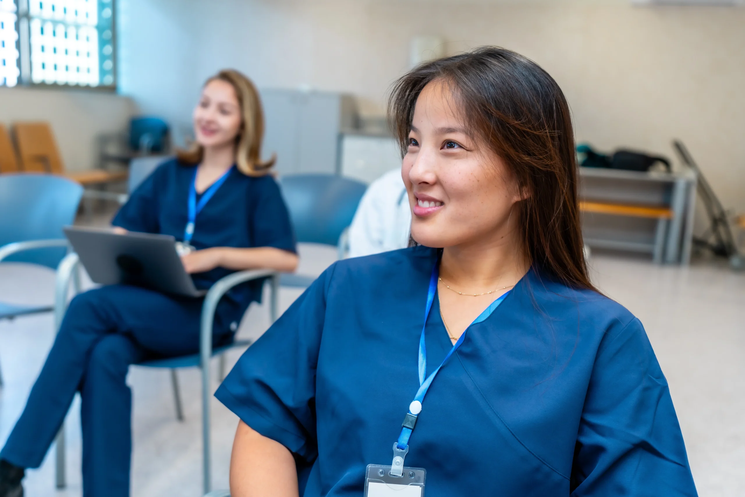 Two students smile in classroom for healthcare career training