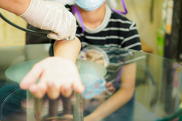 Doctor takes child's blood pressure