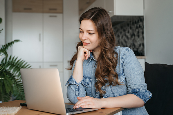 Mom watches webinar on laptop 