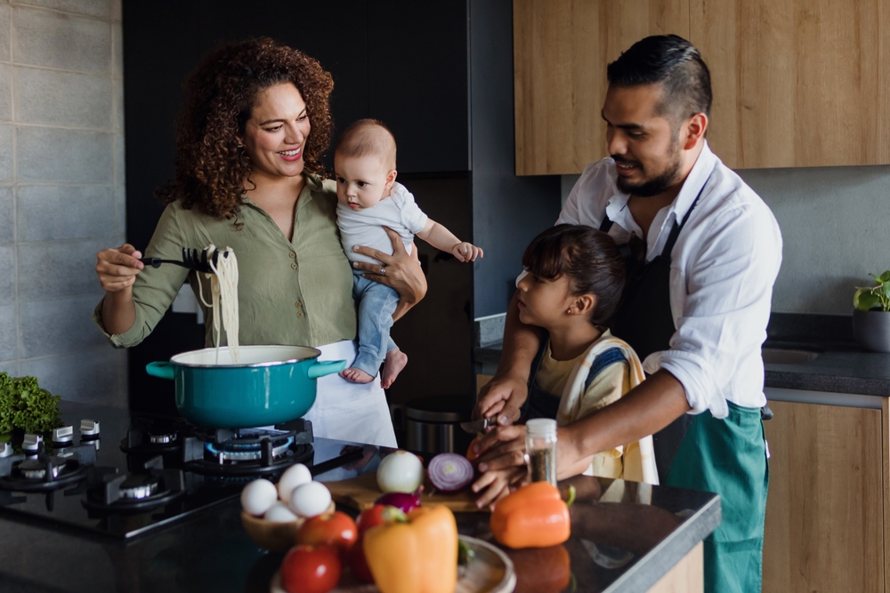 family in kitchen cooking together