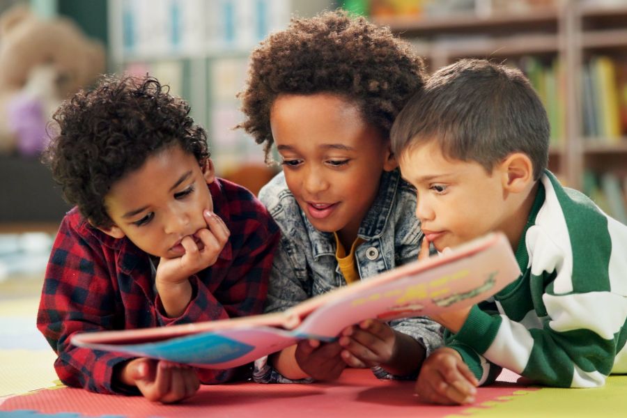 Students look at book together
