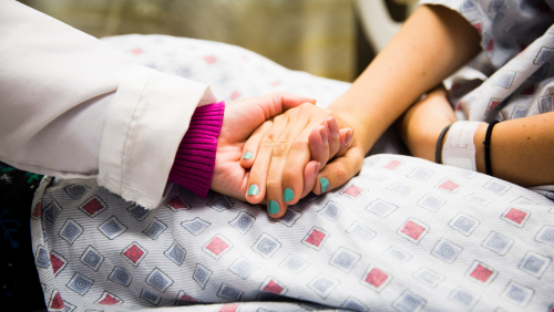 Doctor and patient holding hands