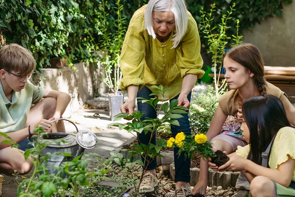 woman and children working on a community garden
