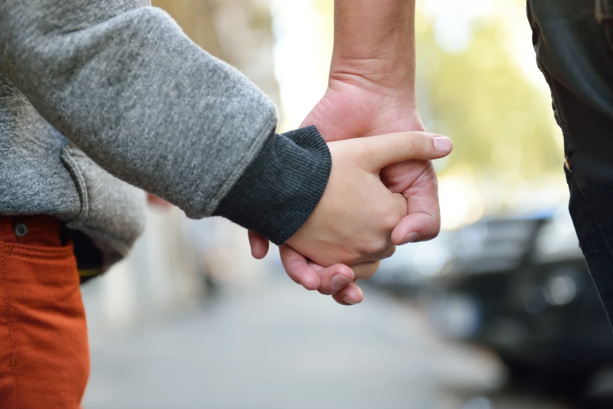 child holding their parents hand